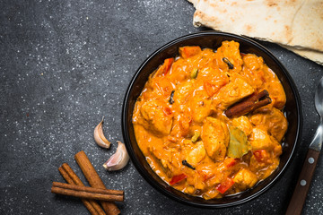 Chicken tikka masala on black top view.