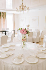 Tables set for an event party or wedding reception. luxury elegant table setting dinner in a restaurant. glasses and dishes.