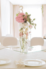 Tables set for an event party or wedding reception. luxury elegant table setting dinner in a restaurant. glasses and dishes.