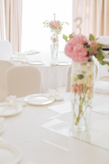 Tables set for an event party or wedding reception. luxury elegant table setting dinner in a restaurant. glasses and dishes.