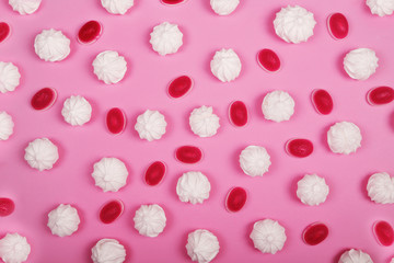 Vanilla meringue cookies on pink background. Top view.