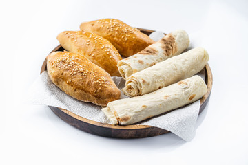 Many mixed breads and rolls shot from above.