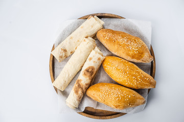 Many mixed breads and rolls shot from above.