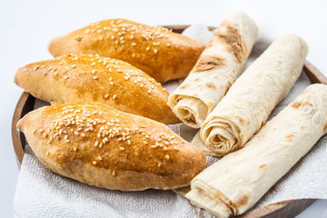 Many mixed breads and rolls shot from above.