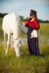 Medieval Princess with a White Horse in a Meadow