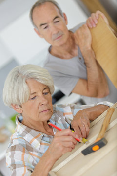 elderly couple with renovation tools