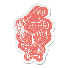 laughing polar bear cartoon distressed sticker of a wearing santa hat