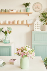 Fototapeta na wymiar bright kitchen in the style of Provence, on the table dishes and a bouquet of flowers in a vase