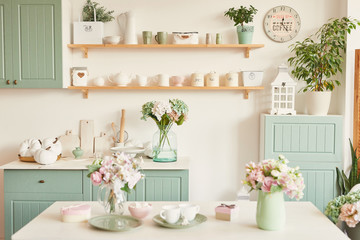 bright kitchen in the style of Provence, on the table dishes and a bouquet of flowers in a vase