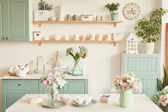 Bright Kitchen In The Style Of Provence, On The Table Dishes And A Bouquet Of Flowers In A Vase