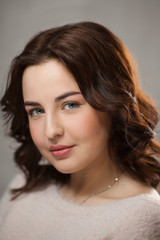 Brunette girl with day nude female face makeup.