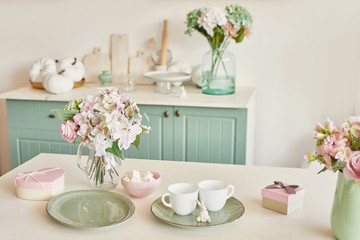 bright kitchen in the style of Provence, on the table dishes and a bouquet of flowers in a vase