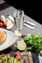 Dry white wine in the glass. Champagne in a beautiful glass on the table. White Georgian wine in a glass.