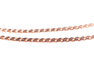 Golden chain weaving non, on a white background. Isolate, macro, soft focus.