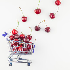 Ripe cherries in a shopping cart isolated © dvoevnore