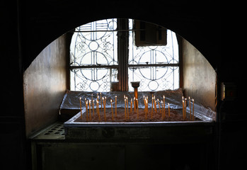 Many burning wax candles in the Saint George's chapel, Mount Lycabettus, Athens, Greece.