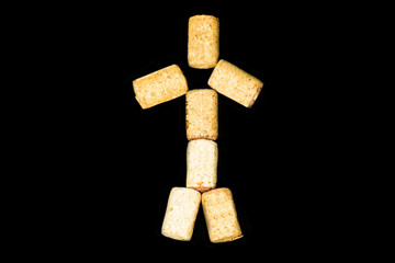 Corks of wine bottles in shape of new year spruce on black background top view
