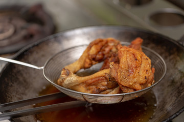 Fried chicken in hot oil and boiling in pan