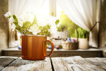 Wooden table of free space for your decoration. Spring window background. Easter eggs and flowers on window sill. 