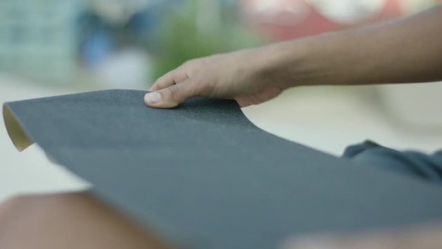Building a skateboard. Using crip tape. Slow Motion. Filmed on Red Dragon