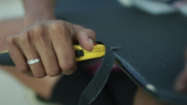Building a skateboard. Using crip tape. Slow Motion. Filmed on Red Dragon