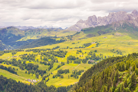 Alpe di Siusi, Seiser Alm with Sassolungo Langkofel Dolomite, a large green field with a mountain in the background © SkandaRamana