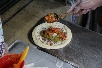 pide master makes pide with meat and vegetables .artvin/turkey