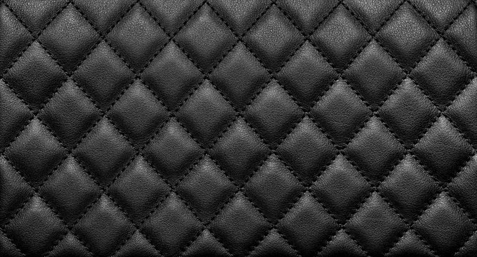Close-up texture of genuine leather with black rhombic stitching