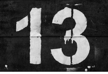 Number 13 in stencil on metal wall in black and white. - obrazy, fototapety, plakaty