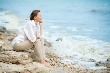 Young woman enjoying life on the ocean coast