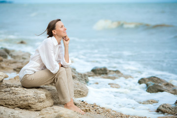 Young woman enjoying life on the ocean coast