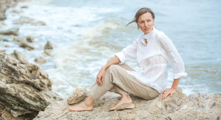 Young woman enjoying life on the ocean coast
