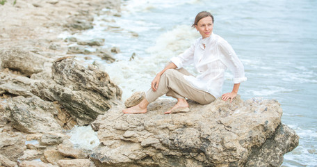Young woman enjoying life on the ocean coast