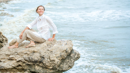 Young woman enjoying life on the ocean coast