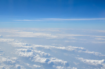 Fototapeta na wymiar The sky with clouds view from airplane window
