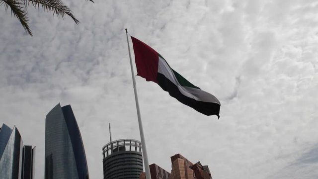 United Arab Emirates flag blowing in the city of Abu Dhabi.