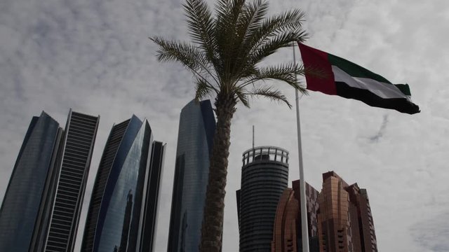United Arab Emirates flag blowing in the wind in the city of Abu Dhabi.