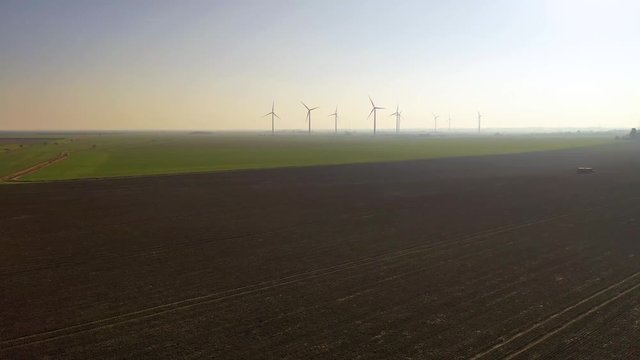 Aerial sequence featuring wind turbines in operation along the Essex coastline at Bradwell-on-Sea.