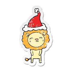 distressed sticker cartoon of a lion wearing santa hat