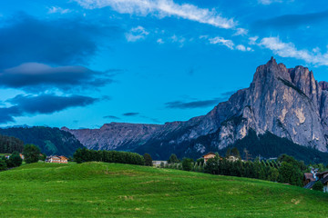 Alpe di Siusi, Seiser Alm with Sassolungo Langkofel Dolomite, a large green field with a mountain in the background