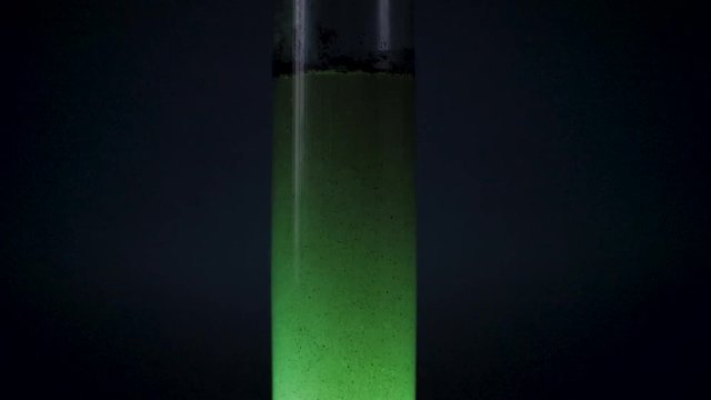 alien tube with green liquid spaceship fuel in slow motion