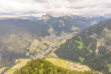 Alpe di Siusi, Seiser Alm with Sassolungo Langkofel Dolomite, a close up of a lush green field in a valley canyon