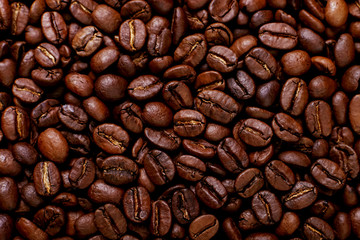 Aroma roasted coffee beans, brown background. Soft focus close up.