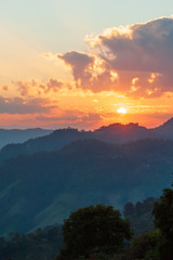 Golden sun setting over mountains near Thailand and Myanmar border.