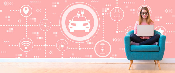 EV with young woman using her laptop in a chair