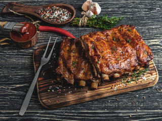 grilled pork ribs with sauce on a cutting board , spice, marinade