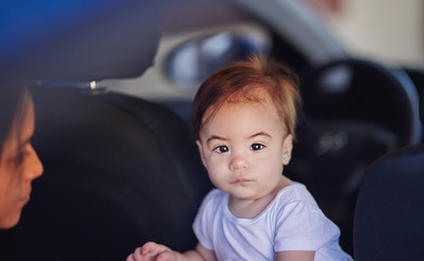Unhappy baby girl in car