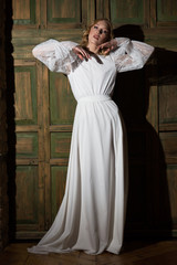 The beautiful young woman posing in a wedding dress