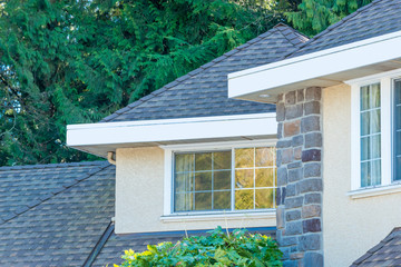 The top of the house or apartment building with nice window.