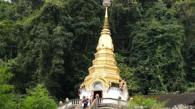 Golden Temple Pagoda in the jungle Wat Tham Pha Plong, Chiang Dao, Thailand. TILT DOWN